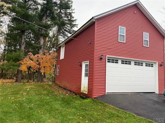 view of home's exterior featuring a garage and a lawn