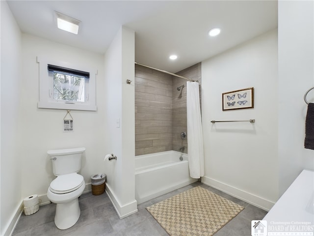 bathroom with toilet and shower / bath combo with shower curtain