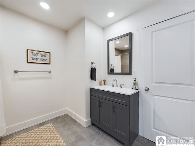 bathroom with a shower with curtain, vanity, and tile patterned flooring