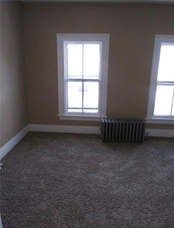 carpeted spare room with radiator