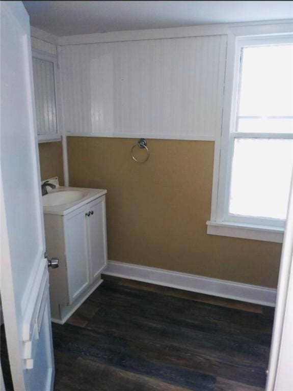 laundry room featuring sink and dark wood-type flooring