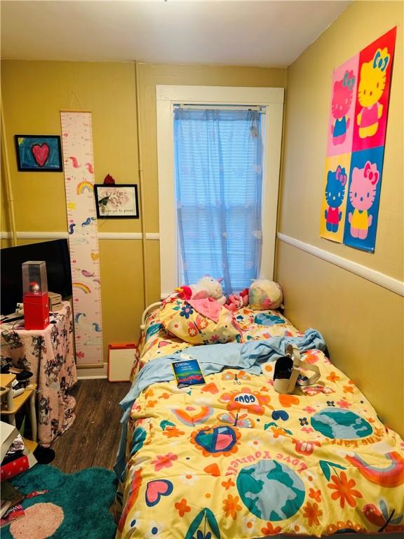 bedroom with dark hardwood / wood-style flooring