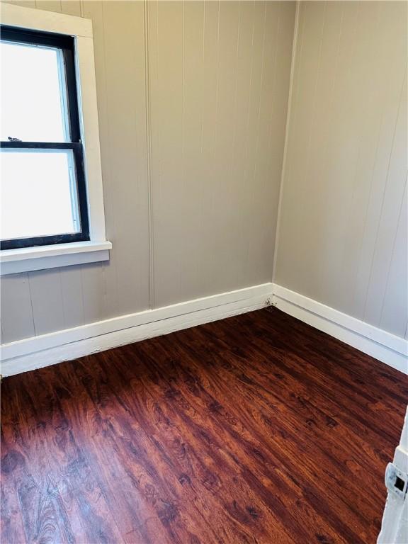 unfurnished room with dark hardwood / wood-style floors