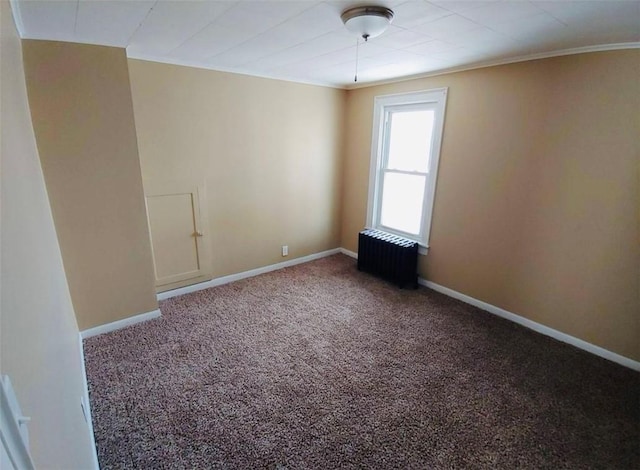 carpeted empty room with radiator heating unit