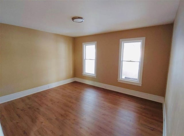 spare room with dark hardwood / wood-style floors