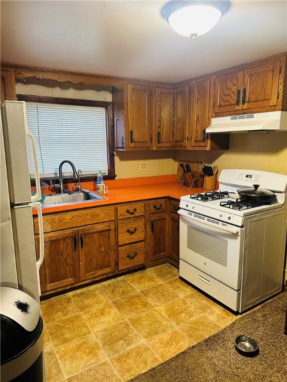 kitchen with white appliances and sink