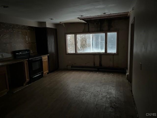 kitchen featuring dark hardwood / wood-style flooring, a baseboard heating unit, and black range with electric cooktop