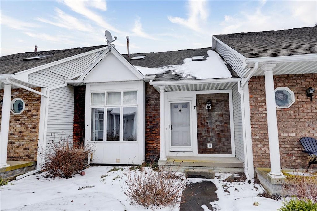 view of snow covered property entrance