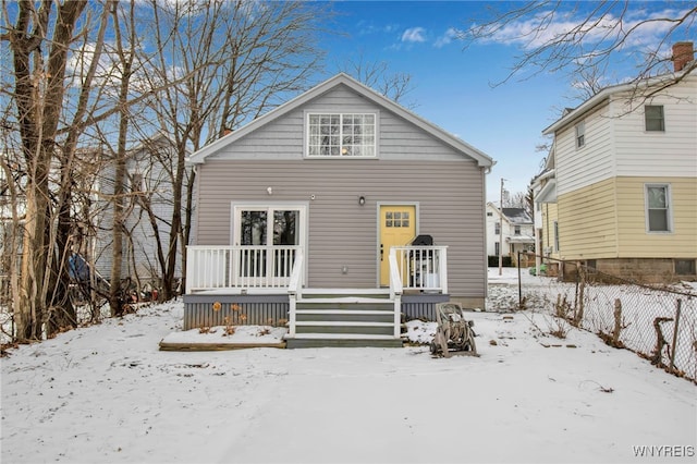 view of snow covered rear of property