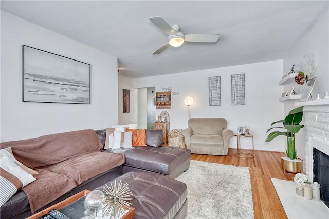 living room with wood-type flooring and ceiling fan