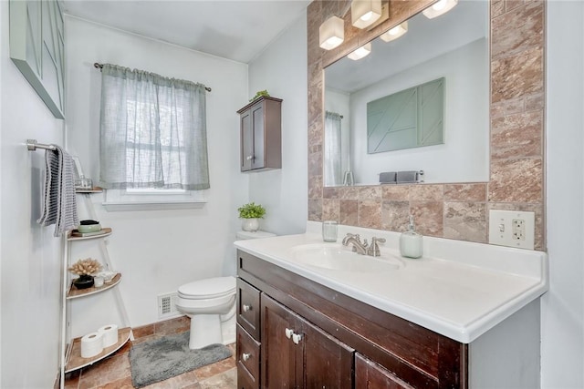 bathroom featuring decorative backsplash, vanity, and toilet