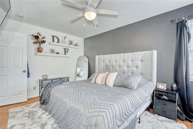 bedroom with hardwood / wood-style floors and ceiling fan