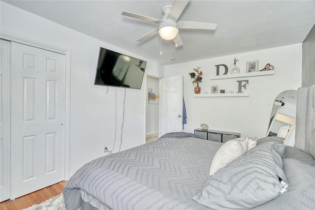 bedroom featuring ceiling fan, wood-type flooring, and a closet