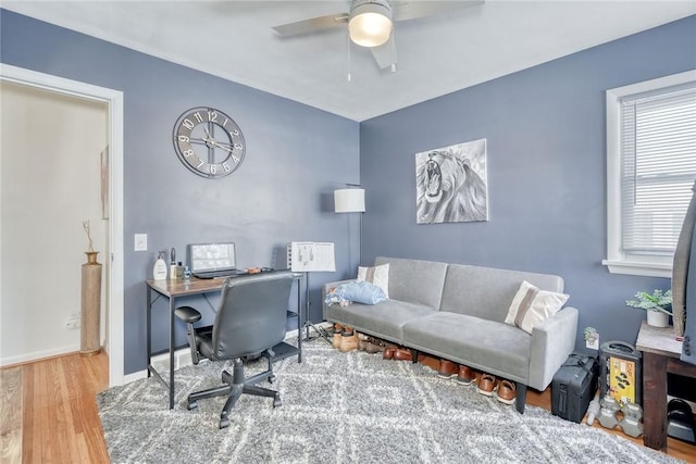 home office featuring hardwood / wood-style flooring and ceiling fan