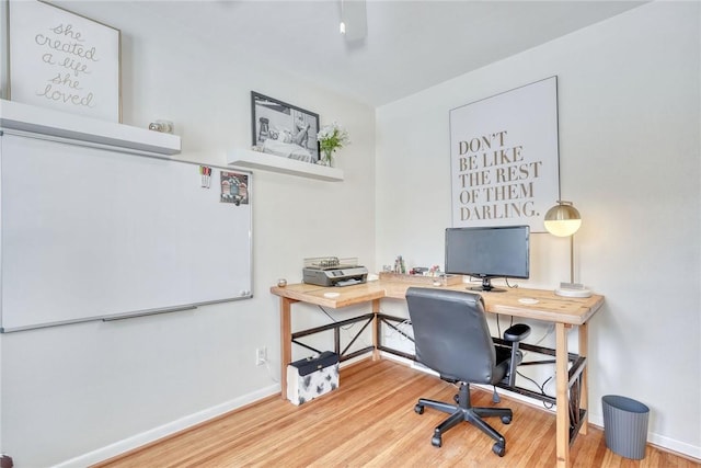 home office with hardwood / wood-style floors