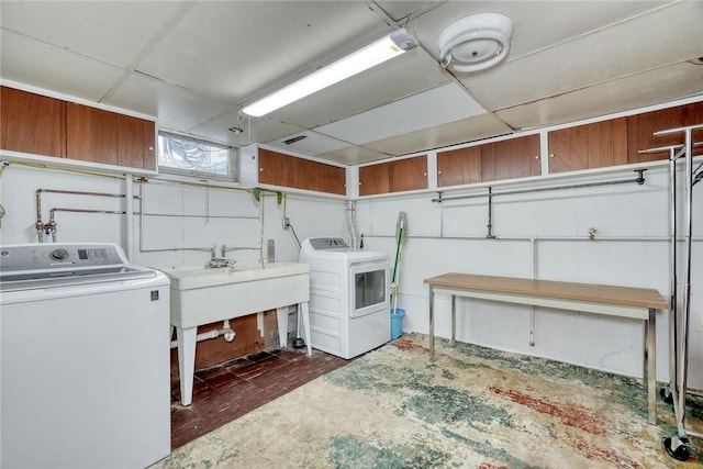 laundry area featuring washing machine and dryer and sink