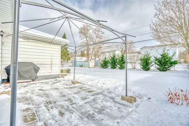 snow covered patio with grilling area