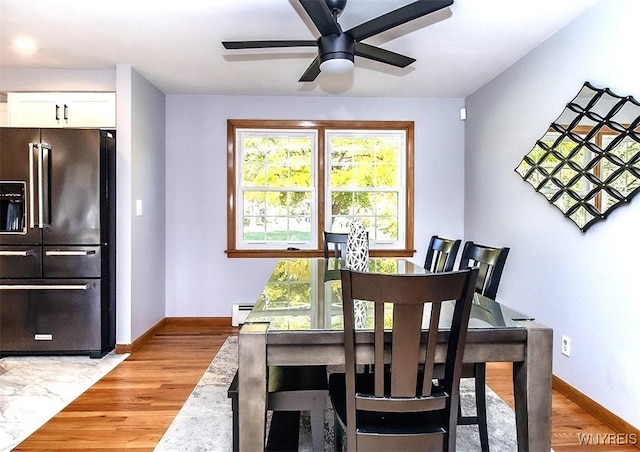 dining room featuring ceiling fan, light hardwood / wood-style flooring, and a baseboard radiator