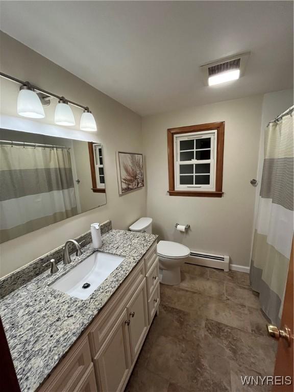 bathroom with vanity, toilet, and a baseboard radiator