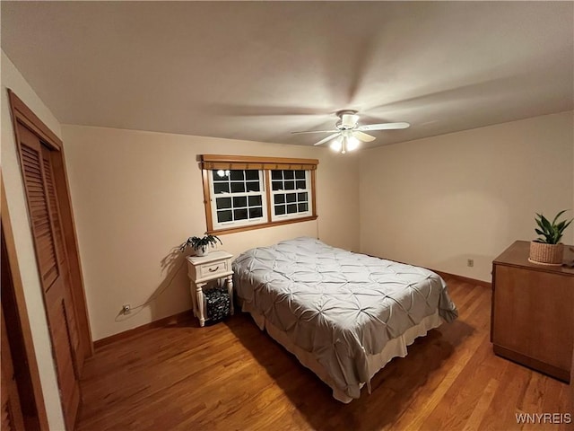 bedroom with wood-type flooring, a closet, and ceiling fan