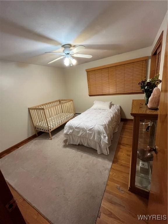 bedroom with hardwood / wood-style floors and ceiling fan