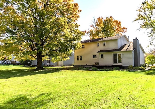 back of property with a lawn