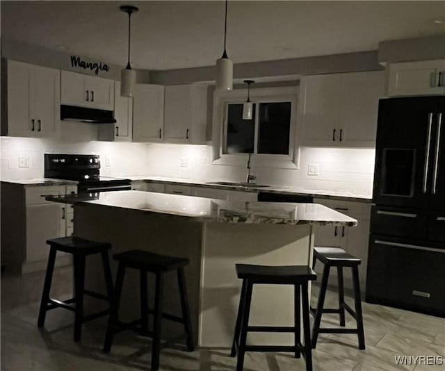 kitchen with white cabinetry, a kitchen island, and black appliances