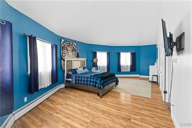 bedroom featuring wood-type flooring and baseboard heating