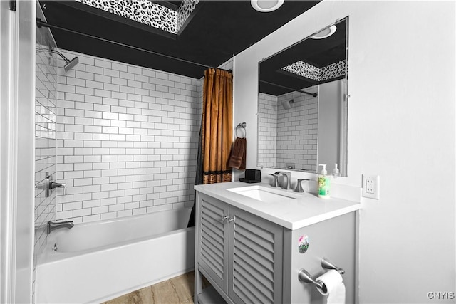 bathroom featuring hardwood / wood-style flooring, vanity, and shower / tub combo