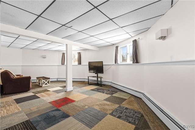 basement with carpet flooring and a paneled ceiling