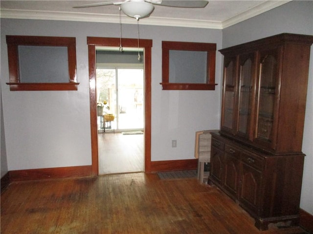 unfurnished dining area featuring dark hardwood / wood-style flooring, ceiling fan, and ornamental molding