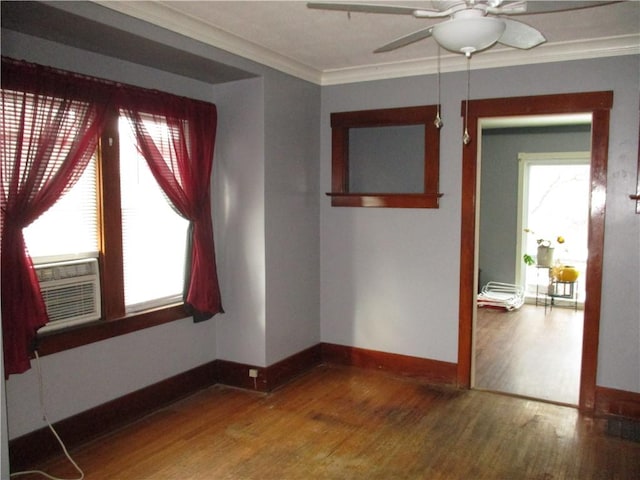 empty room with ceiling fan, wood-type flooring, and ornamental molding