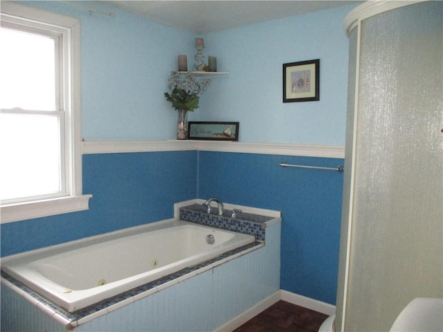 bathroom featuring tiled bath