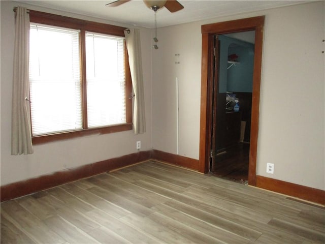 empty room featuring ceiling fan and light wood-type flooring