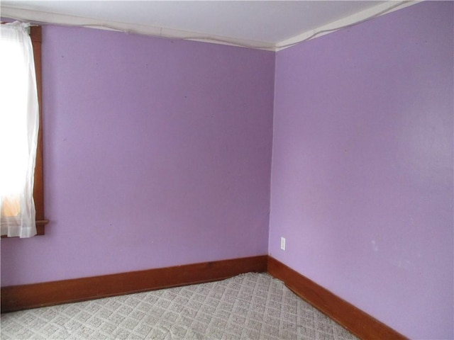 unfurnished room featuring light carpet