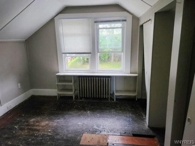 bonus room featuring lofted ceiling and radiator heating unit