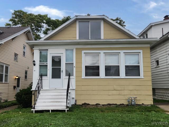 back of house with a lawn