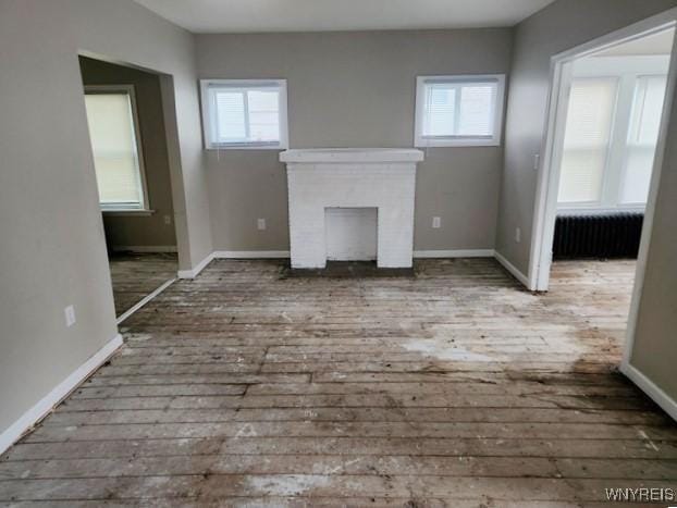 unfurnished living room featuring radiator heating unit