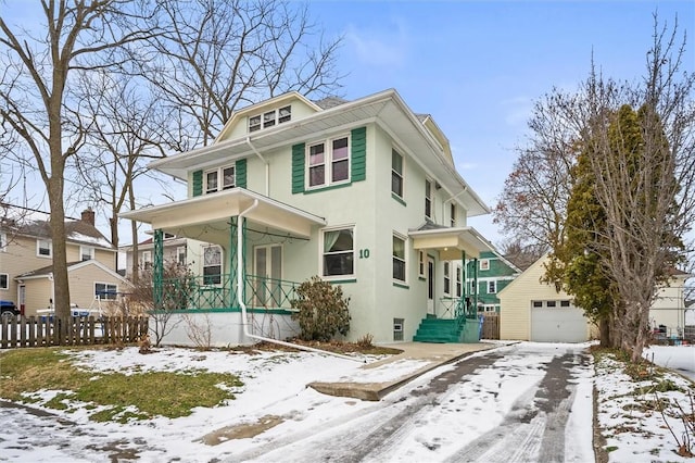 view of front of home featuring a porch, a garage, and an outbuilding