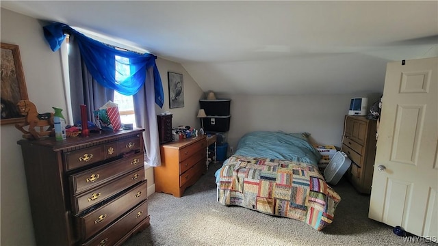 carpeted bedroom with lofted ceiling