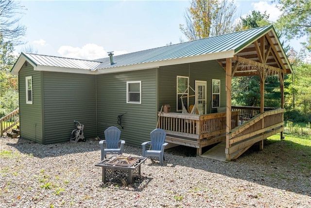9539 Bronson Rd, Dansville, NY 14572 - back of property with a fire pit and a wooden deck