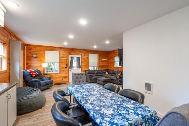 9539 Bronson Rd, Dansville, NY 14572 - dining space with light hardwood / wood-style flooring and wooden walls
