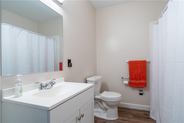 9539 Bronson Rd, Dansville, NY 14572 - bathroom featuring hardwood / wood-style floors, vanity, and toilet