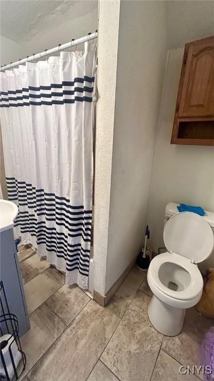 bathroom with a shower with curtain, vanity, and toilet