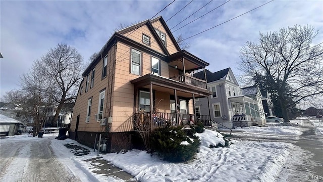 view of front of property featuring covered porch and a balcony