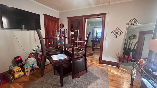 home office featuring crown molding and hardwood / wood-style flooring