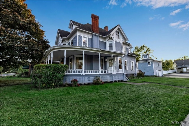 victorian home with covered porch and a front lawn