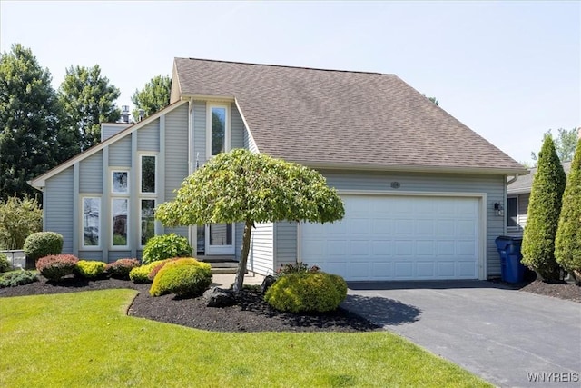 view of front facade featuring a front yard and a garage