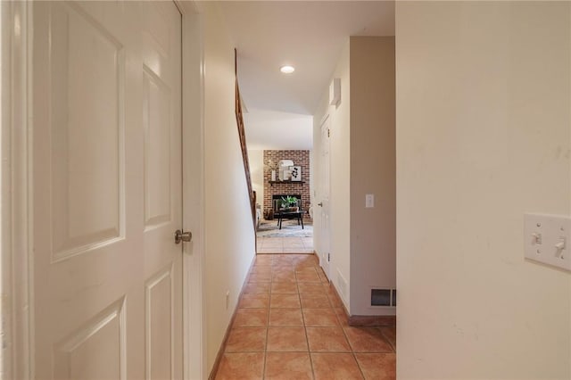 corridor featuring light tile patterned floors