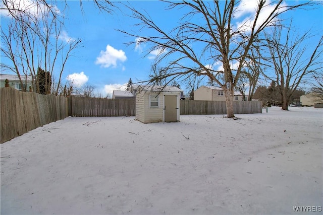 yard covered in snow featuring a shed